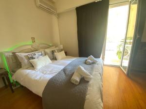 a bedroom with a large bed with towels on it at 150m² Live/Work Unique&Sunlit Space in Athens in Athens