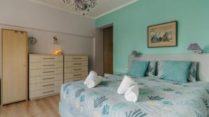 - une chambre avec un lit et des serviettes dans l'établissement Crystal Villa Patras, à Patras