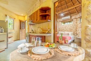 a kitchen with a table with plates of food on it at Alaya Tulum by Ahau Collection in Tulum +83 photos
