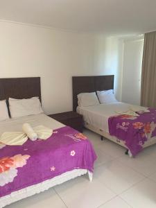 Cama ou camas em um quarto em Beach Class Muro Alto Condomínio Resort - New Time