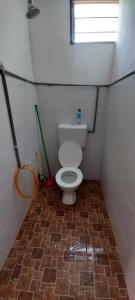 a small bathroom with a toilet in a room at Hometostay Bokbak Kupang 