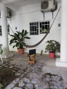 a room with a hammock in front of a building at Las Palmas in Zihuatanejo