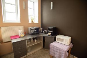 a kitchen with a counter top with a microwave and a microwave at Aiakeskuse hostel in Rakvere