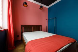 a bedroom with blue and red walls and a bed at Apartments in Kaunas in Kaunas