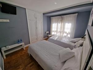 Postel nebo postele na pokoji v ubytování Hostal Fidalgo