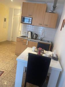 a kitchen with a white table with two chairs at Schöne und Gemütliche Wohnung in Trier Zentrum in Trier