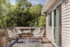 a patio with chairs and a table on a deck at LARGE 5 Bed Lake Geneva Home 4 Blocks from Lake! in Lake Geneva