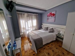 Postel nebo postele na pokoji v ubytování Hostal Fidalgo