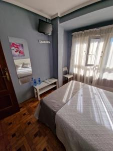 Postel nebo postele na pokoji v ubytování Hostal Fidalgo