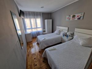 Postel nebo postele na pokoji v ubytování Hostal Fidalgo