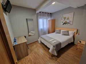 Postel nebo postele na pokoji v ubytování Hostal Fidalgo