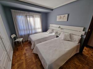 Postel nebo postele na pokoji v ubytování Hostal Fidalgo