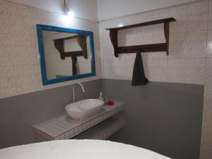 a bathroom with a sink and a mirror at Furaha Lodge in Jambiani