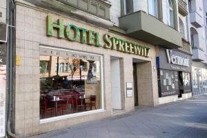 a restaurant with a sign on the side of the building at Hotel Spreewitz am Kurfürstendamm in Berlin