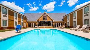 a swimming pool in front of a building at SureStay Plus Hotel by Best Western Wytheville in Wytheville