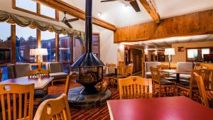 a restaurant with a fireplace and tables and chairs at SureStay Plus Hotel by Best Western Wytheville in Wytheville