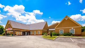 a large building with an empty parking lot at Deluxe Inn Wytheville in Wytheville
