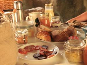 a table with two plates of food on it at Fragas do Lobo - Casa da Azenha in Castelo Novo