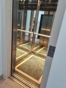 an elevator door in a building with a window at ALBERTI APARTAMENTS in Campana