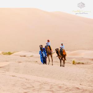 two people riding on horses in the desert at Pueblo Touareg - Private Tents in Merzouga