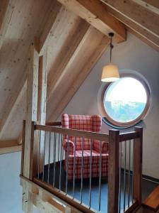 ein Wohnzimmer mit einem roten Sofa und einem runden Fenster in der Unterkunft Beim Schlafwandler in Virneburg