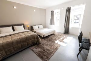 Postel nebo postele na pokoji v ubytování OPERA Hotel