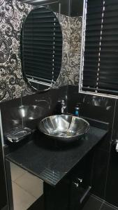 a bathroom with a sink and a mirror at Upmarket 3 Bedroom Apartment in Johannesburg