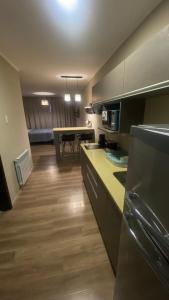 a kitchen with a counter and a table in it at Casa de Playa in Necochea +10 photos