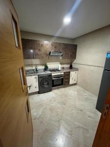 a kitchen with a stove and a stove top oven at Place Mozart - centre-ville in Tangier