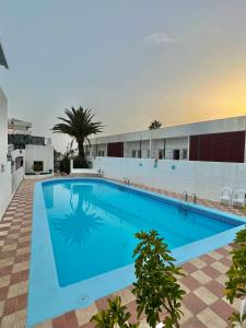 a large blue swimming pool in a building at Silver & Brownie, Nuevo apart cerca de la Playa in Playa de las Americas