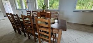 a dining room table and chairs with a plant on top at La Colonie in Publier
