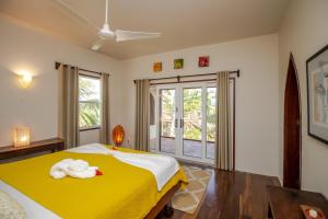 a bedroom with a bed with a towel on it at La Perla del Caribe - Villa Jade in San Pedro +33 photos