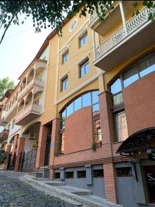 duży budynek z oknami wychodzącymi na ulicę w obiekcie Aura Plaza Hotel w mieście Tbilisi City