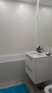 a white bathroom with a sink and a mirror at Lovely Sunrise in Bucharest +13 photos