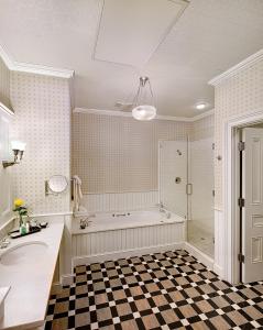 a bathroom with a tub and a sink and a shower at Wentworth Mansion in Charleston