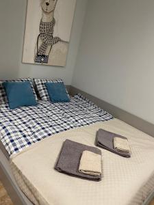 a bedroom with two beds with towels on them at IX PIĘTRO - 9th floor apartment in Katowice in Katowice