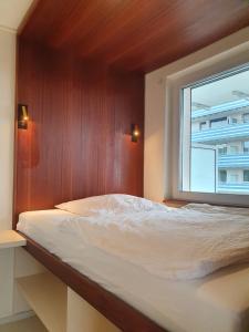 a bedroom with a large bed with a window at Apartment Frankfurt City View - Oberursel in Oberursel