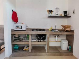 a kitchen with a counter with a microwave on it at Casa Loma Flamingos Ixtapa in Ixtapa
