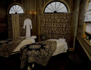 a room with two beds and a robe in it at Wentworth Mansion in Charleston