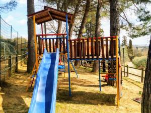 a playground with a blue slide at Agriturismo Vernianello in Poggibonsi