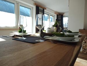 a wooden table with wine glasses and bananas on it at Apart Oetz in Oetz