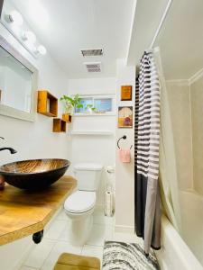 a bathroom with a toilet and a sink at Sunrise Tree BnB - your Home away from home in Toronto