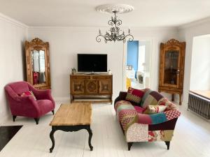 a living room with a couch and a table at Shabby Chic - apartment in the Heart of Vilnius Old Town in Vilnius