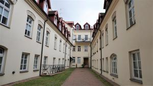 an alleyway between two buildings in a city at Shabby Chic - apartment in the Heart of Vilnius Old Town in Vilnius