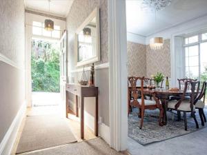 a dining room with a table and chairs in a room at Glenthorne Villa Torquay in Torquay