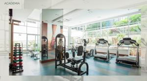 a gym with several treadmills and machines in a room at Sky Duplex - Cobertura TOP e Moderna em Condomínio Completo (NOVO) in Sao Paulo