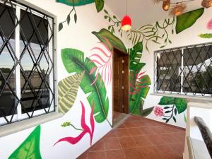 a room with a mural on the wall at Castillo Tulum in Tulum