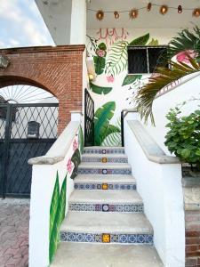 a set of stairs in front of a building with graffiti at Castillo Tulum in Tulum