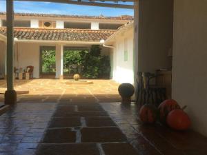 a patio with pumpkins on the floor of a house at La Nube Posada in Barichara