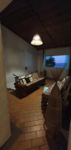 a room with a bed and a table and a lamp at Pousada Farol do Patacho in Pôrto de Pedras